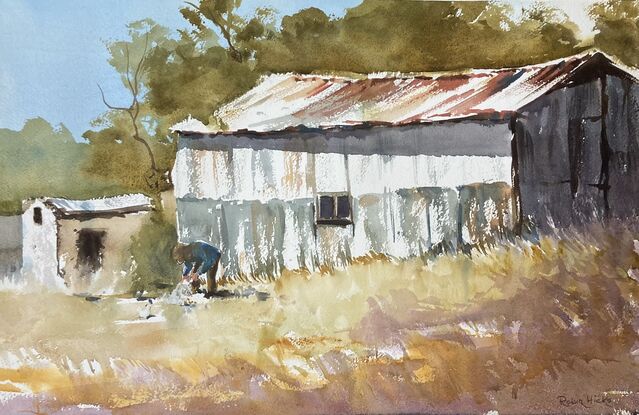 Rustic rusty shed with farmer in front feeding chooks