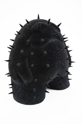 A black spiky figure covered in a black and glitter velvet flock. 