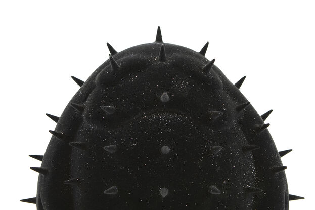 A black spiky figure covered in a black and glitter velvet flock. 