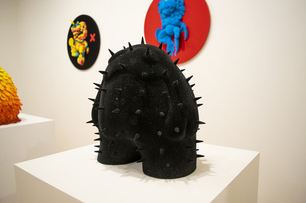 A black spiky figure covered in a black and glitter velvet flock. 