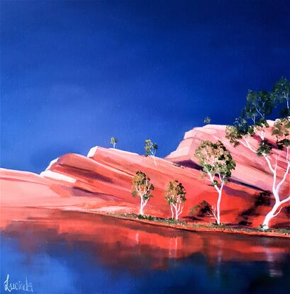 Australian landscape in oranges and deep blue sky with  gum trees and water reflections