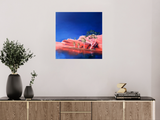 Australian landscape in oranges and deep blue sky with  gum trees and water reflections