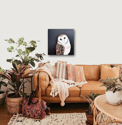 Oil painting portrait of an Australian Masked Owl on a black background. The owl has a white heart shaped mask around its face, has bronze and brown feathers on its back and wings and a white breast.