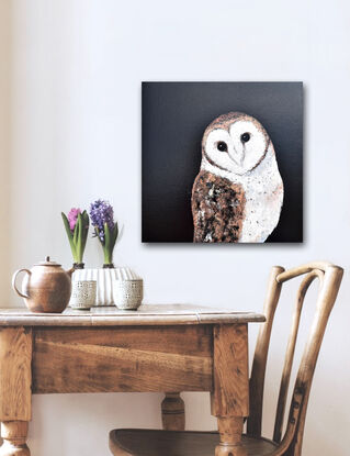 Oil painting portrait of an Australian Masked Owl on a black background. The owl has a white heart shaped mask around its face, has bronze and brown feathers on its back and wings and a white breast.