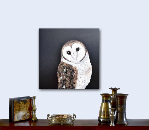 Oil painting portrait of an Australian Masked Owl on a black background. The owl has a white heart shaped mask around its face, has bronze and brown feathers on its back and wings and a white breast.