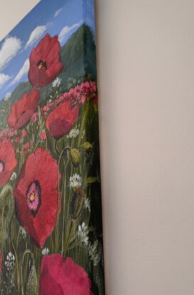 A breathtaking painting showcases a vast field blanketed with radiant red poppies, their petals vibrant and full of life. The poppies sway gently, creating a sea of red that seems to go on endlessly. Above, the sky is a brilliant shade of blue, providing a stark and beautiful contrast to the red below. The atmosphere is serene and peaceful, with the beauty of nature taking centre stage. The simplicity of the scene, devoid of any symbols or distractions, allows the viewer to immerse themselves fully in the tranquil beauty of the poppy field.