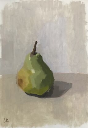 A green yellow pear on a grey background 