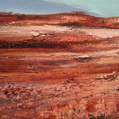 Outback sky with red ochre outcrops