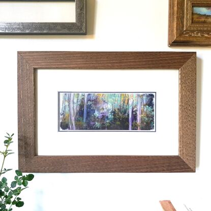 Framed miniature oil painting in purple and blues with mustard, of a sunlit sapling forest with dense understory scrub. By Victoria Collins. Frame is solid wood, dark toned. 