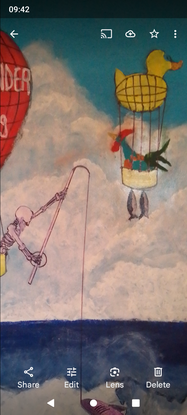 My work depicts two large, colourful hot air balloons manned by fantasy figures catching large fish out of the surf.