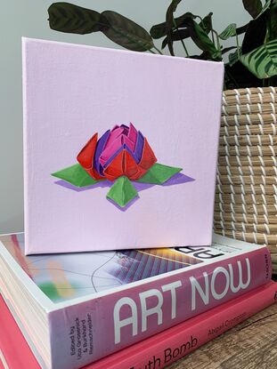 Origami flower in pink, red, purple and green