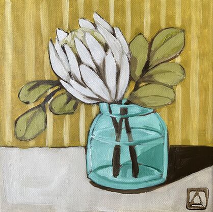 White protea in a glass vase with a striped background