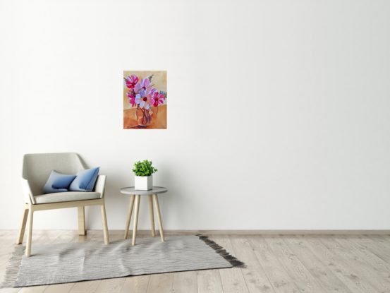 Flowers in a glass water jug.
