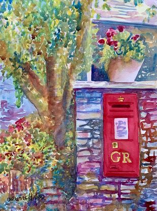 Red postbox set into the wall in Grasmere in the Lake District, UK 
