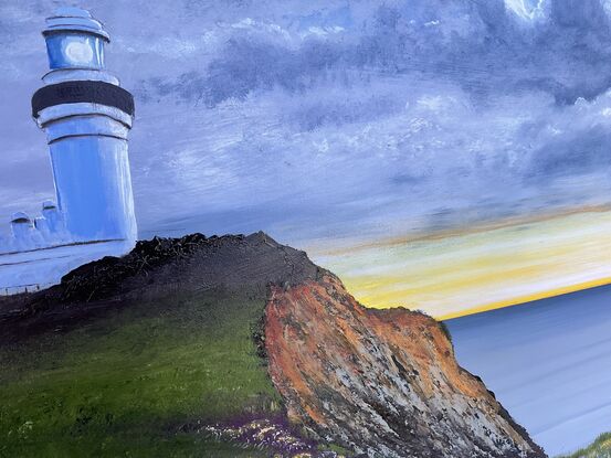 Lighthouse on the hill filled with wildflowers 