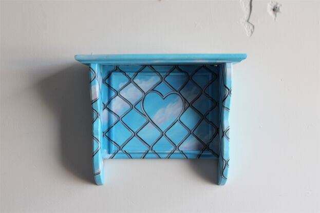 An old wooden shelf painted with a clear blue sky and security door mesh overlayed.