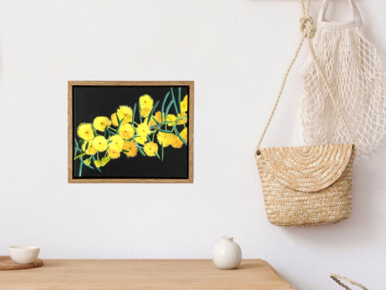 Explosions of bright yellow wattle on a dark blue background. Framed in natural wood.