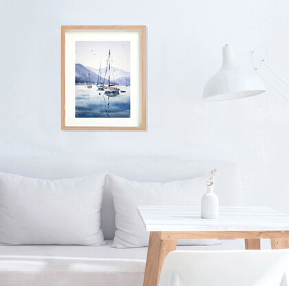 sailboats on water with reflections. Blue colours with mountains in the distance.