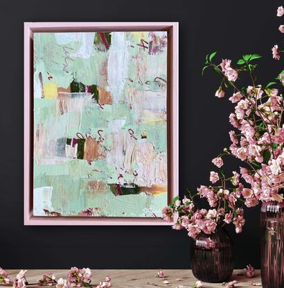 Pale green and pink, layered with text and texture, in a pink timber frame