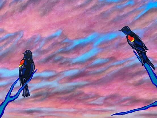 Black-winged birds overlooking a colorful pink dawn reflected on a bog.