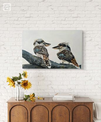 Two kookaburras perched gracefully on a sturdy tree branch, their vibrant feathers standing out against the muted backdrop of the grey sky. Their beauty adds a touch of vibrancy to the scene, capturing the eye with their vivid colors and lively presence.