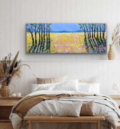 Bold striking brown black trees in two groups on the sides of the painting contrast with the sunny yellow fields   The striking  tree shadows create drama and interest against the medley of sunshine whilst  splashes of electric colour warm the scene. This is a striking piece to add vibrancy and interest to a room. There is an underlying feeling of positivity and happiness with the bright colour. 