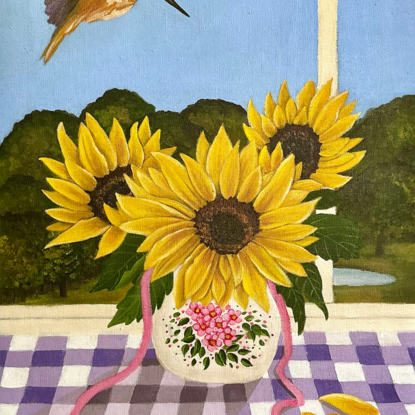 vase of 3 sunflowers on a purple gingham table cloth against a window view hinterland inspired landscape scene