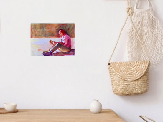 An artwork showing a man reading a book in the shade.
