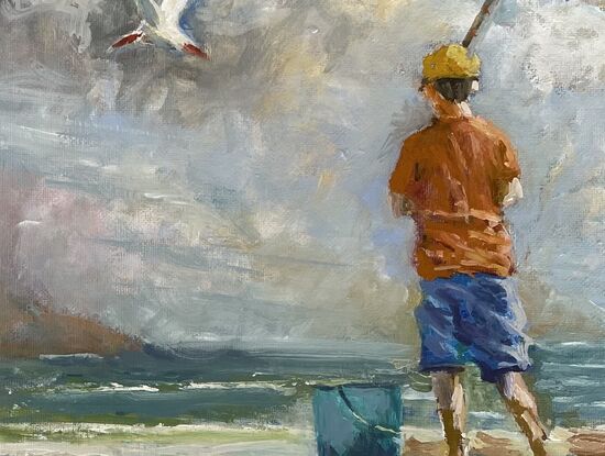 Boy fishing on a beach
