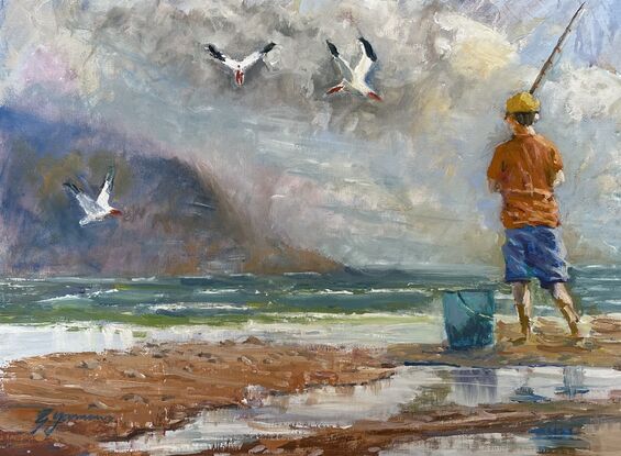 Boy fishing on a beach
