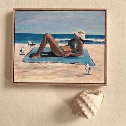 Woman reclining on a beach towel. 