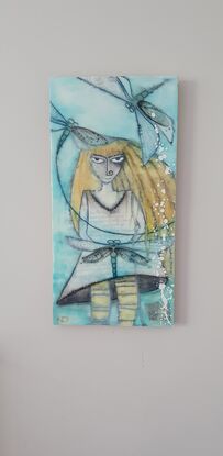 Encaustic art depicting yellow haired girl with dragonflies swirling about her