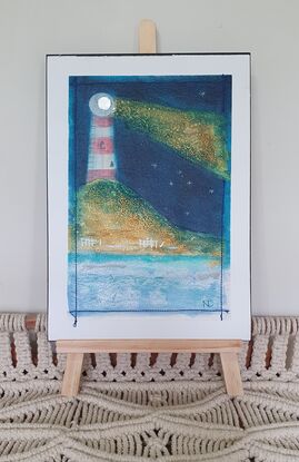 Oil painting of lighthouse and stars accented with stitching.