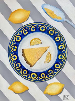 Slice of citrus tart on a blue and yellow plate on striped grey and white tablecloth 