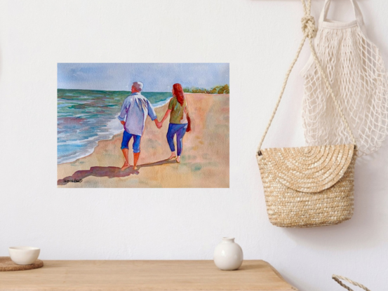 An artwork showing a couple walking hand in hand on the beach.