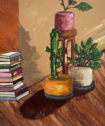 A stool, a stack of books, pot plants in a living room
As the afternoon light filters in 