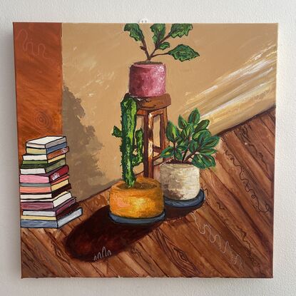 A stool, a stack of books, pot plants in a living room
As the afternoon light filters in 