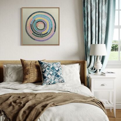 Cream  background, vibrant lines of rainbow making up a circular shape 