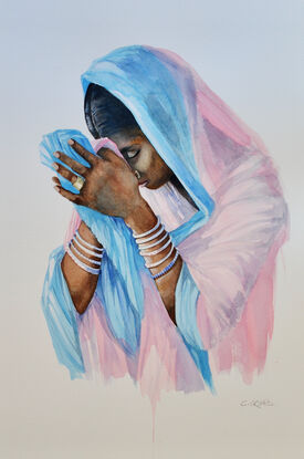 A woman praying in India on the banks of the Ganges.