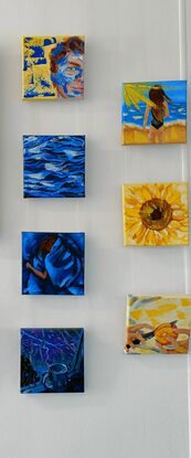 There are 7 small square paintings. There are a variety of subjects, one portrait of a man, two of a young woman (wrapped in a blanket & at the beach), water, a mug in a rainy window, a sunflower and hands slicing up an orange. 