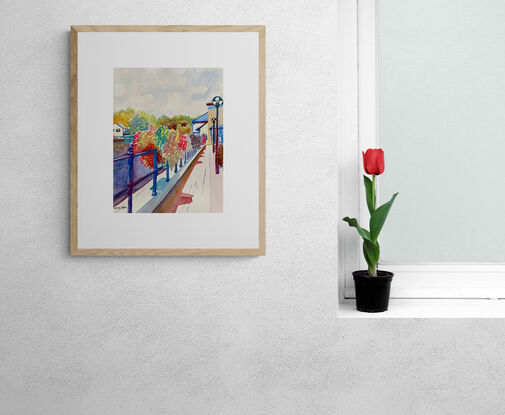 An artwork showing a display of flower baskets adorning the railings between a canal and a public house.