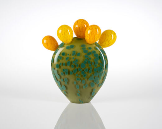 Upright glass sculpture, a large green flat leaf with five rounded yellow buds attached on the top.