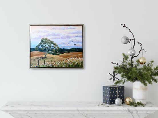 rolling hills, gum trees, farm fences and wildflowers on sunset