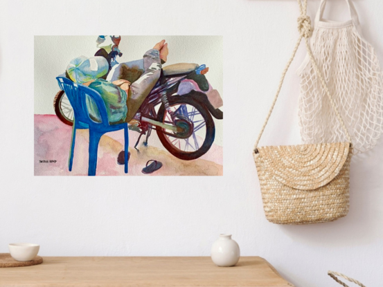 artwork showing a man asleep resting his legs on his motor bike
