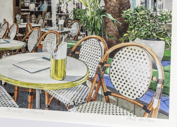 This busy,  cafe corner in Hastings Street with typical French cafe chairs lined on  the footpath and shadowed by large green poincianas has attracted tourists and locals for their morning coffee for many years.  A few locals are seated before the rush enjoying their first coffee of the day.  Internal lighting with chandeliers  define the internal dark walls and drink cabinets behind  and provide a sophisticated tonal  ambience. 