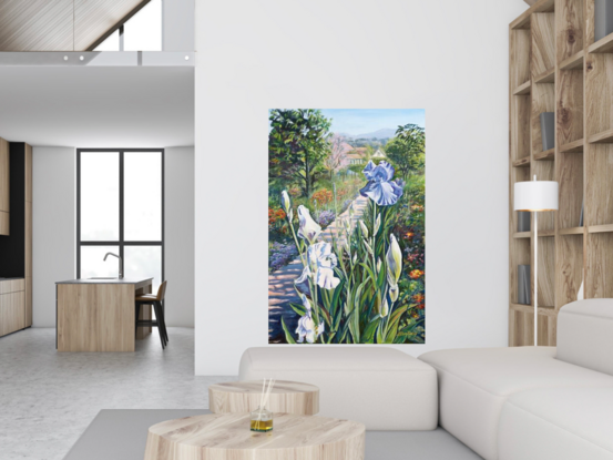 Purple Iris in the foreground with a path leading to Monet's house, lined with lush bedding plants and  trees, in soft lilacs, pinks and greens against a pale blue sky, on a portrait orientation canvas with a tradition carved cream coloured frame.