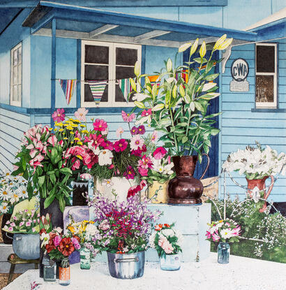 Market Stall in front of the original blue & white painted  Eumundi CWA Hall.  Vases and containers of brightly coloured country style flowers stand on different levels covered in lace tablecloths with a colourful striped bunting hanging above the stall.