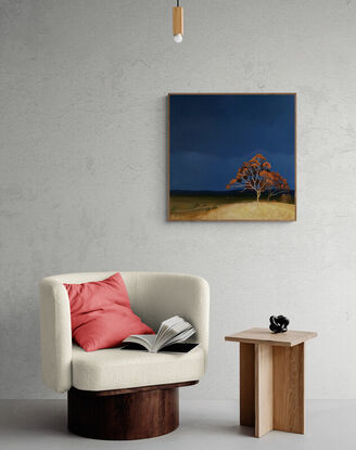 Australian landscape with a deep blue sky and orange trees on the hill in the foreground