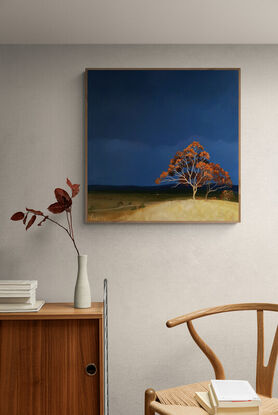 Australian landscape with a deep blue sky and orange trees on the hill in the foreground