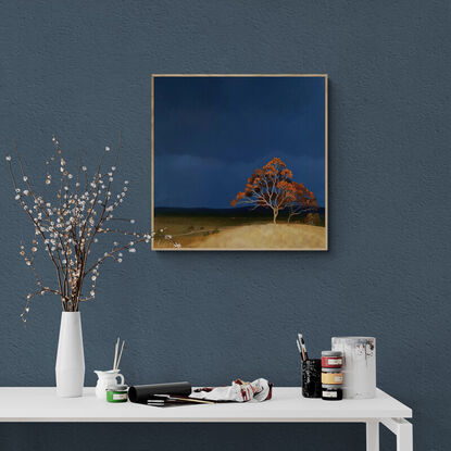 Australian landscape with a deep blue sky and orange trees on the hill in the foreground